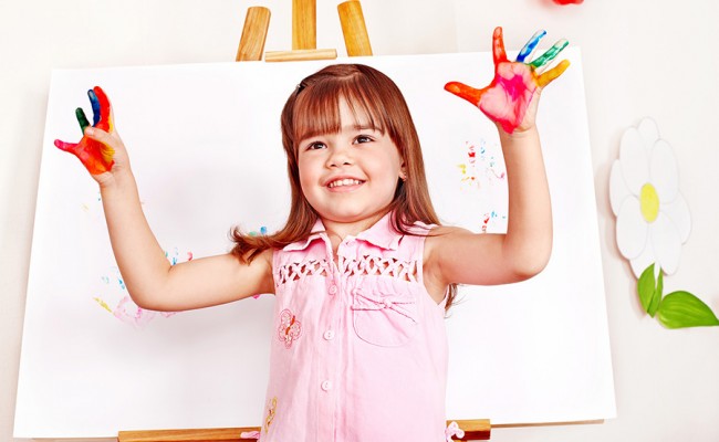 Child paint picture in preschool.